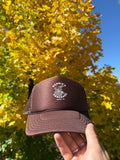 Bonnie's Powder Stack Trucker hat front view featuring Aspen Mountain shredding girl logo